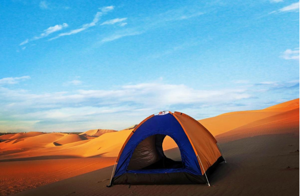 A tent in the desert Description automatically generated with low confidence